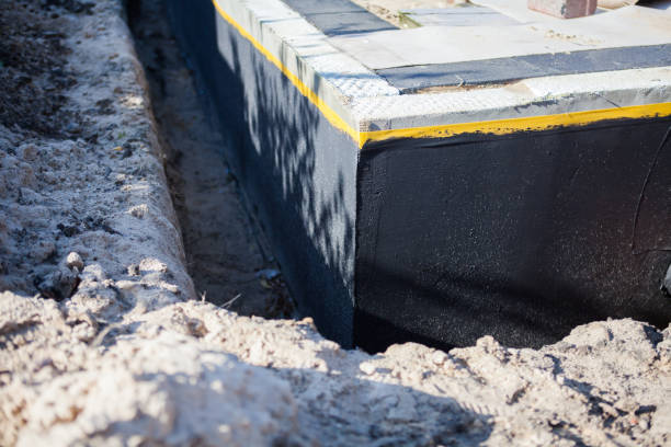 Professional Basement Waterproofing technician working in Raymond, IL
